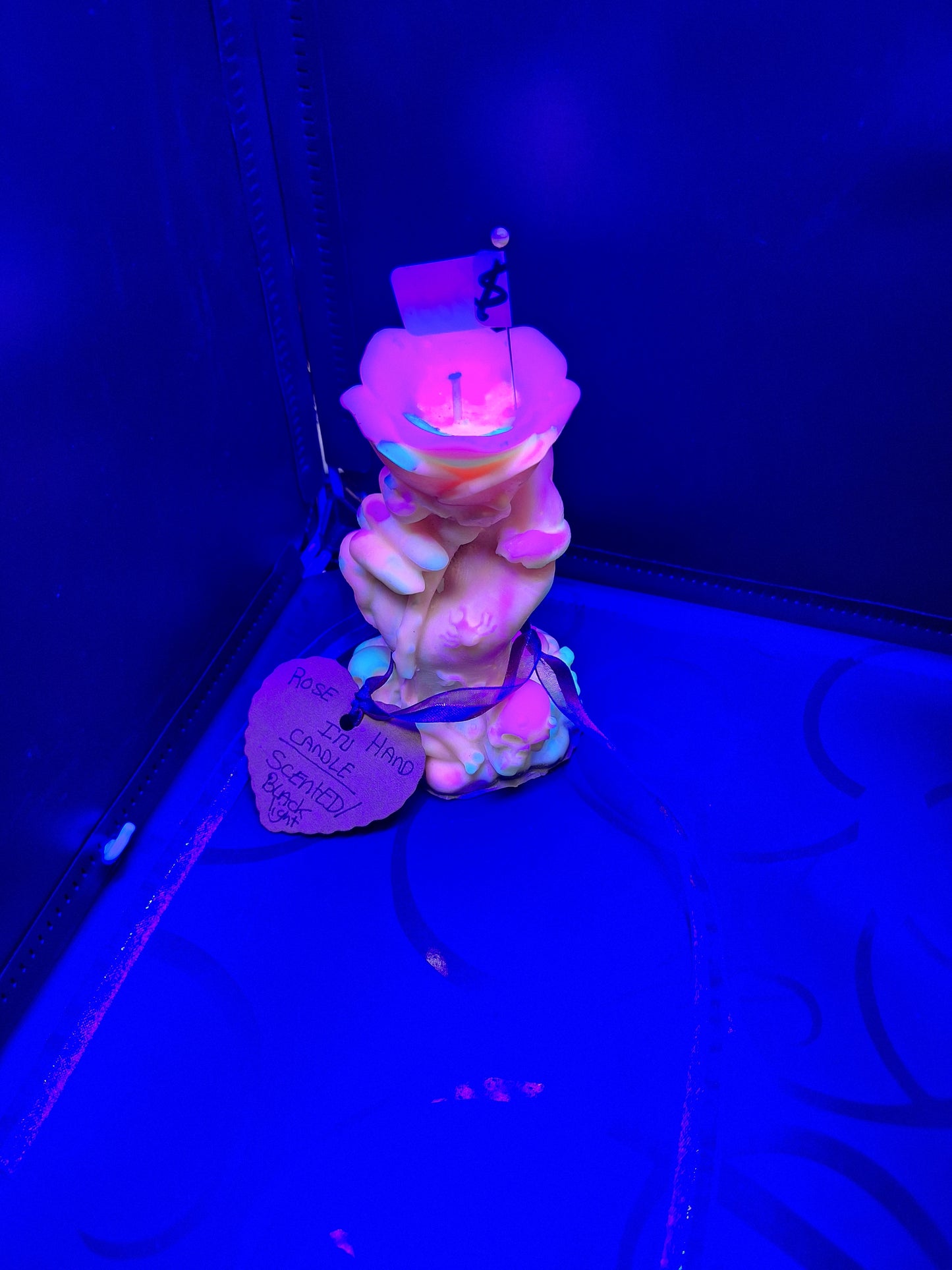 Blacklight rose in hand candle scented