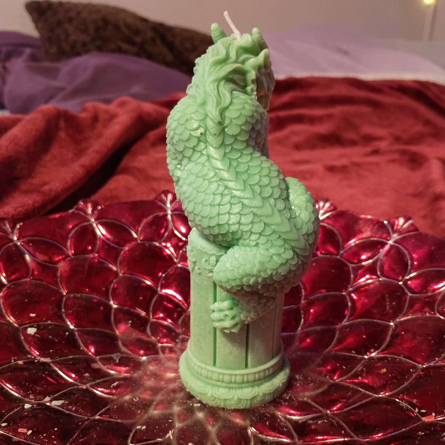 Green dragon on statue candle