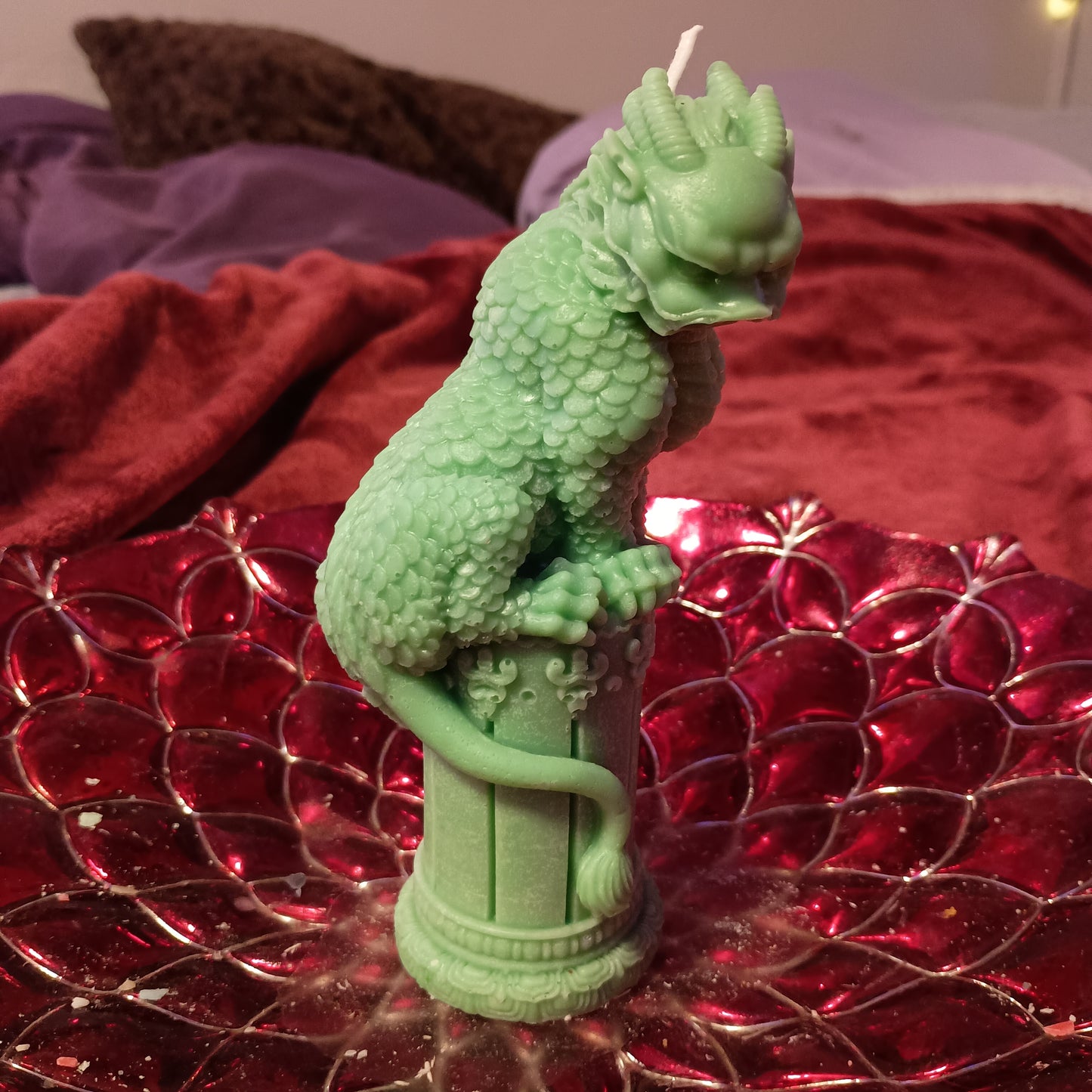 Green dragon on statue candle