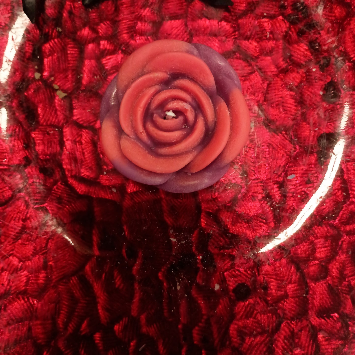 Red and purple flower candle