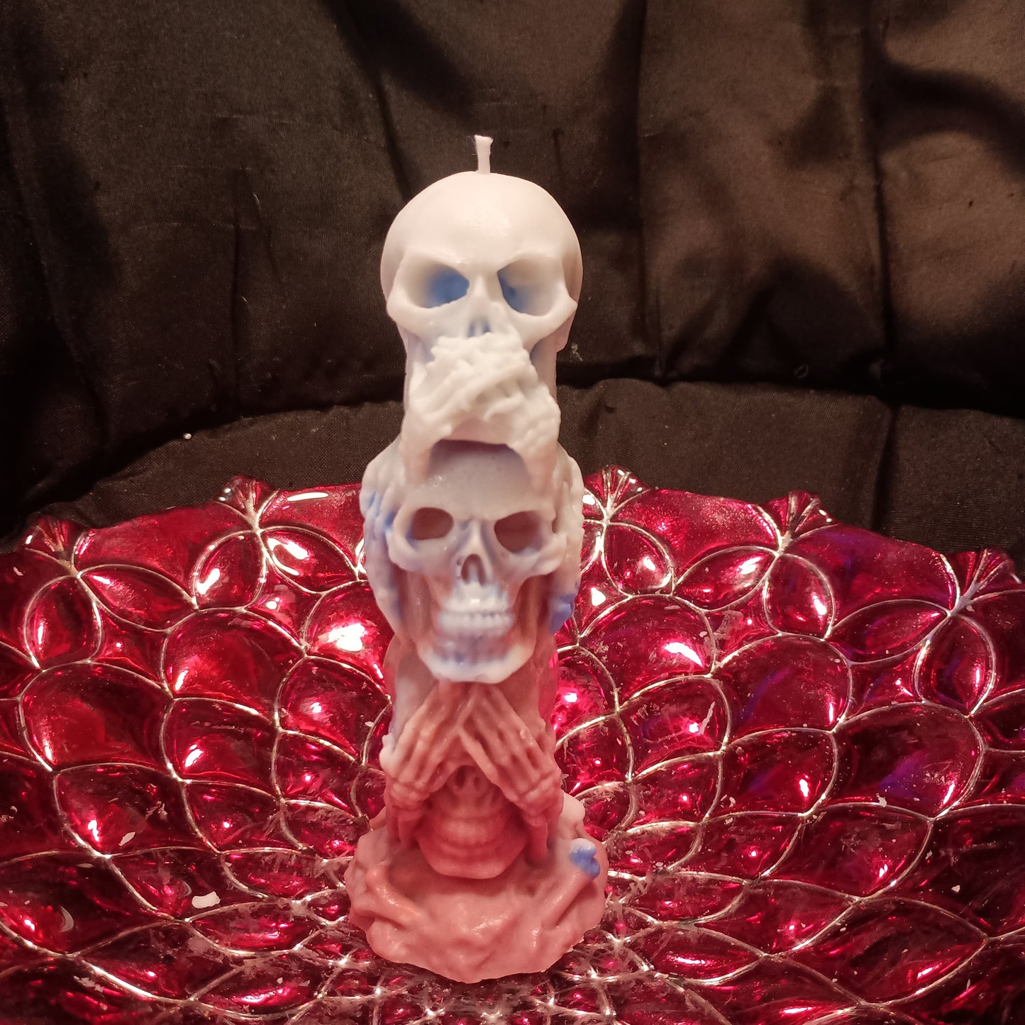 Red white and blue tower of skulls candle