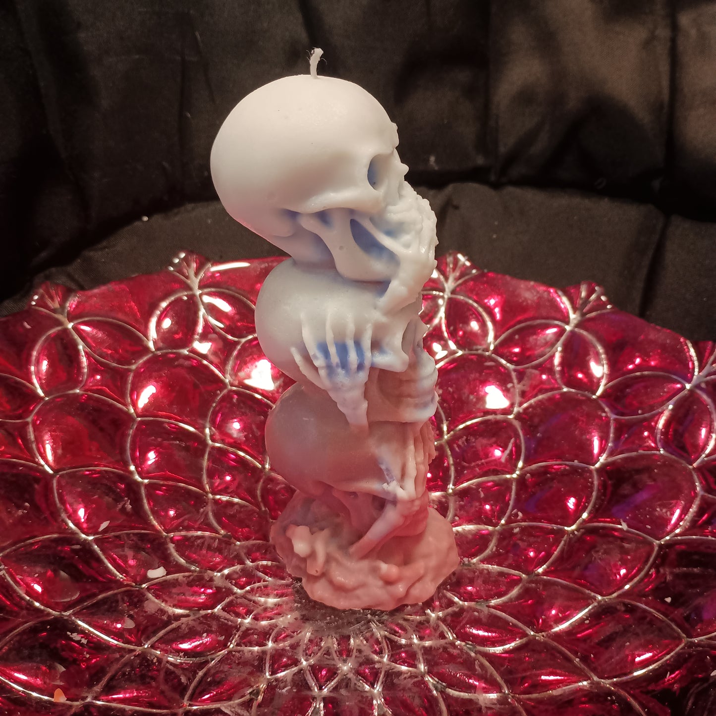 Red white and blue tower of skulls candle