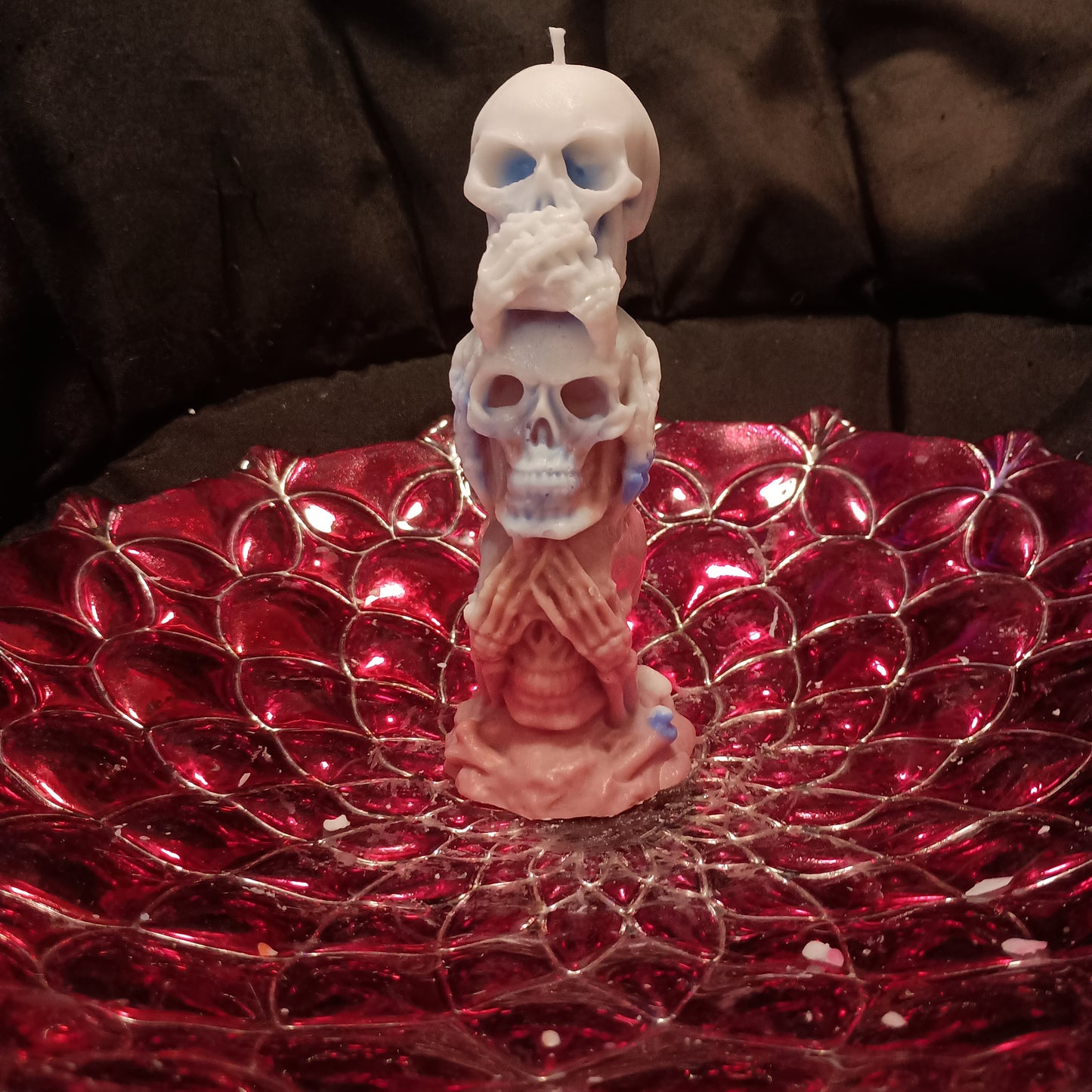 Red white and blue tower of skulls candle