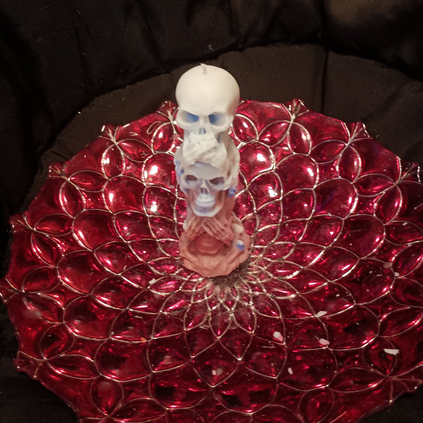 Red white and blue tower of skulls candle