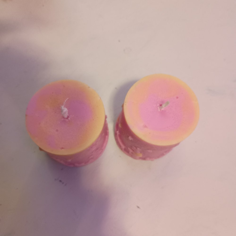 Pair of pink and yellow Christmas themed scented piller candles14